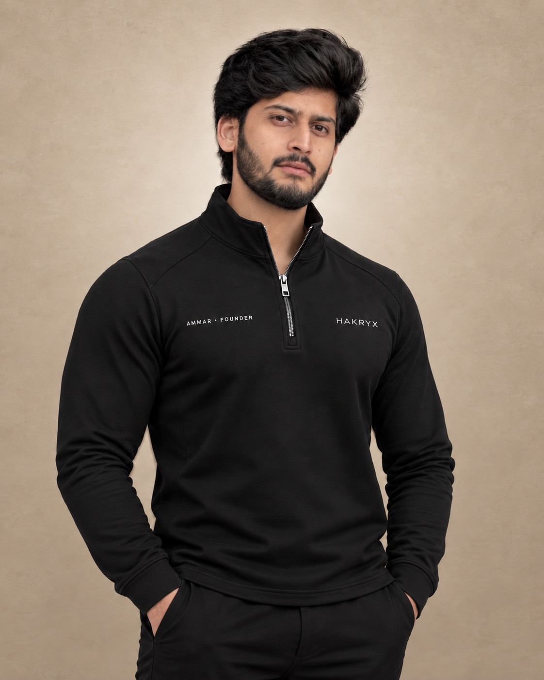 Ammar, founder of HAKRYX, wearing a black HAKRYX quarter zip.